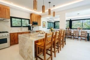 Modern kitchen with wooden cabinets, island, and mountain view windows.
