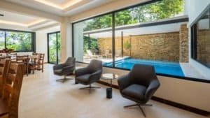 Modern interior with pool and rainforest view in Dominical estate.