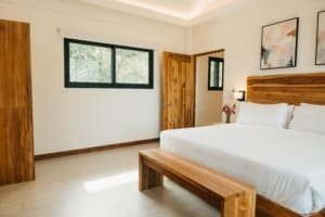 Modern bedroom with wooden furniture and mountain view window.