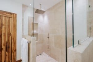 Modern rainforest shower in a luxurious bathroom with glass enclosure.
