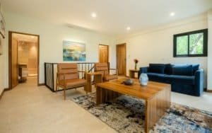 Spacious living room with modern furniture and mountain views in Dominical.