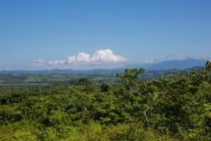 Stunning ocean and mountain view from a lush green landscape in Dominical.