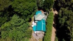 Aerial view of a house with saltwater pool surrounded by lush greenery in Dominical.
