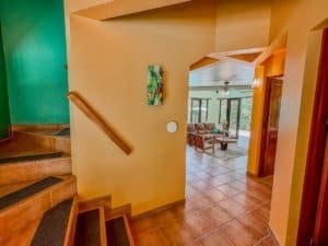 Living room with large windows and tropical scenery in Dominical.