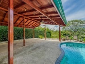 Outdoor covered patio with pool and scenic greenery in Dominical.