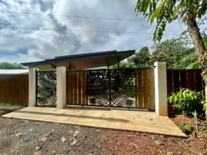 Contemporary tropical home with stylish gate and lush surroundings in Dominical.