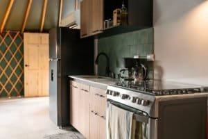 Contemporary kitchen with black and wood cabinets in Dominical Costa Rica.