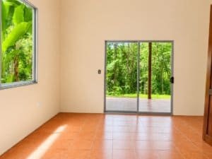 Bright room with large sliding glass door and jungle view in Dominical.