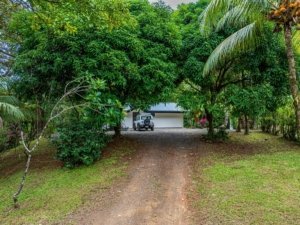 Secluded rainforest home with driveway and garage in Dominical, Costa Rica.