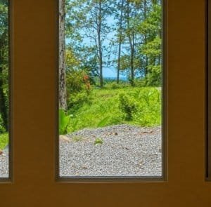 View of lush jungle and trees from a window in Dominical, Costa Rica.