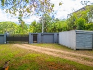 Secure gated entrance with a metal storage container in Dominical.
