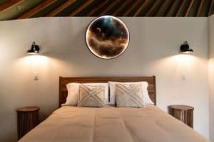 Modern bedroom with celestial moon wall art and cozy decor in Dominical.