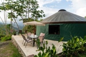 Eco-lodge in Dominical with outdoor seating and mountain scenery.