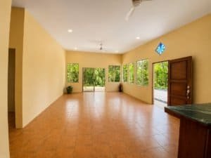 Bright living room with large windows and jungle views in Dominical.