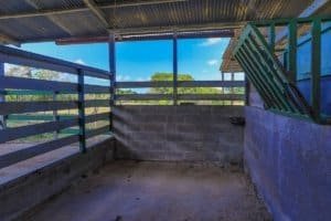 Stable with concrete floor and wooden fencing in Dominical real estate property.