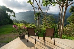Chairs and potted plant overlooking lush mountains in Dominical, Costa Rica.