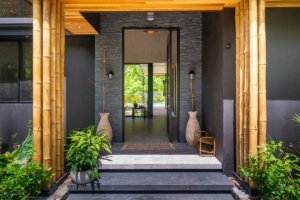 Modern Japanese style home entrance with bamboo and lush greenery in Dominical.