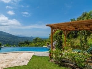 Luxury Costa Rica home with infinity pool and lush garden view.