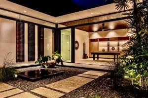 Modern luxury home interior with indoor garden and open living space.