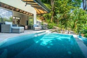 Modern pool and outdoor living space in lush Costa Rica setting.
