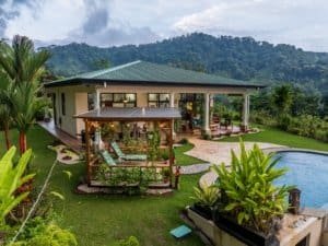 Elegant home with infinity pool, manicured garden, and mountain view in Dominical.