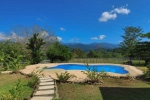 Swimming pool with mountain and lush greenery in Dominical Costa Rica.