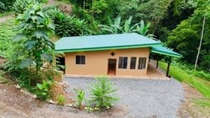 Cozy 2-bedroom jungle home with green roof in Costa Rica's lush forest.