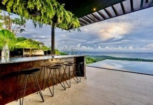 Modern outdoor bar with ocean and mountain views in Dominical, Costa Rica.