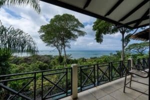 Balcony view of lush greenery and ocean in Dominical, Costa Rica.