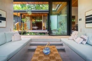 Modern Japanese style home with pool surrounded by lush jungle greenery.