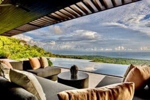 Modern outdoor living space overlooking ocean and lush landscape in Dominical.