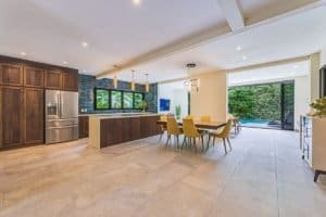 Spacious kitchen and dining area with large windows and pool view.