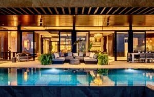 Modern luxury home with pool, ocean view, and stylish interior design.
