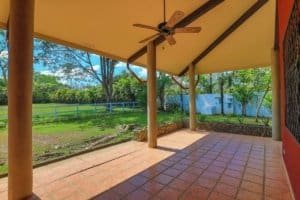 Relaxing porch with ceiling fan overlooking lush green landscape in Dominical.