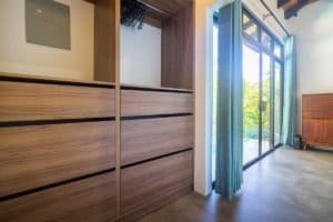 Bright room with sliding glass doors and wooden furniture in Dominical.