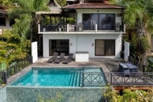 Luxury villa with ocean view, pool, and outdoor lounging area in Dominical.