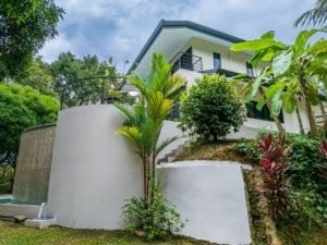 Modern rainforest home with pool, surrounded by lush tropical plants in Dominical.