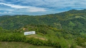 Scenic view of lush green hills and Maersk container in Dominical.