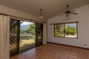 Interior of hacienda style home with large windows and scenic outdoor view.