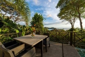 Scenic ocean view from villa balcony with outdoor dining area in Dominical.