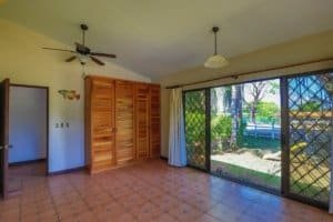 Spacious room with large sliding glass doors and wooden closet in Costa Rica.