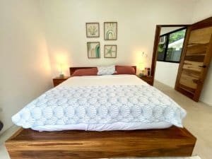 Bright bedroom with modern decor and tropical art in Dominical.