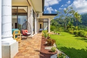 Beautiful outdoor patio and garden of a luxury Costa Rica home with mountain view.