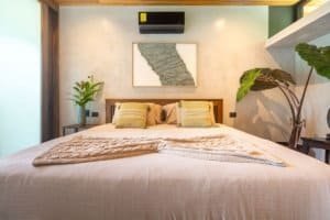 Stylish bedroom with tropical plants and minimalist decor in Costa Rica.