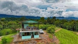 Modern house with balcony overlooking lush jungle and mountains in Dominical.