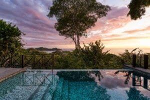 Scenic ocean view from a poolside villa in Dominical at sunset.