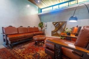Cozy Japanese-inspired living room with leather furniture and a grand piano.