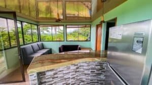 Modern office with large windows and mountain views in Dominical, Costa Rica.