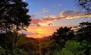 Beautiful sunset view over lush rainforest in Dominical, Costa Rica.