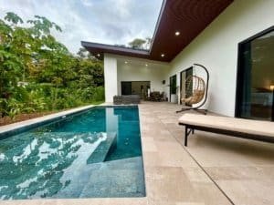 Luxury modern tropical home with private pool and outdoor seating area.